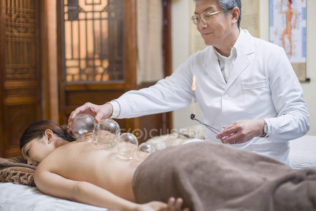 Chinese woman receiving vacuum cupping treatment — Stock Photo