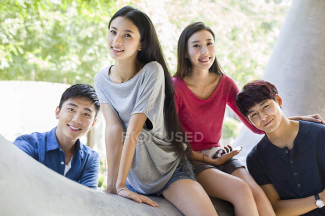 Chinese men and women posing on street together — Stock Photo