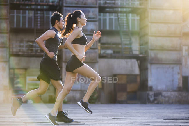 Chinese joggers running on street — Stock Photo