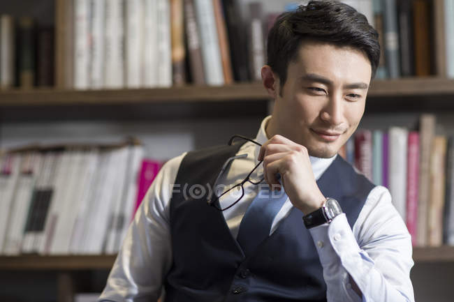 Portrait of asian businessman in study — Stock Photo