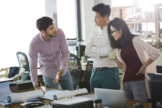 Architects discussing blueprints in office — Stock Photo