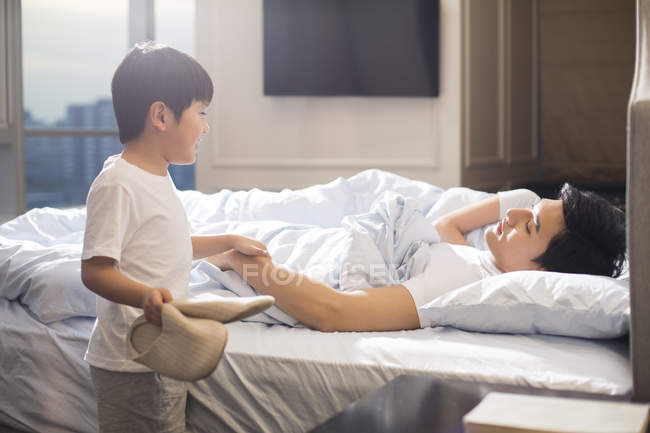 Chinese Boy With Slippers Waking Up Parents In Bedroom Chinese Ethnicity Father Stock Photo 178420134