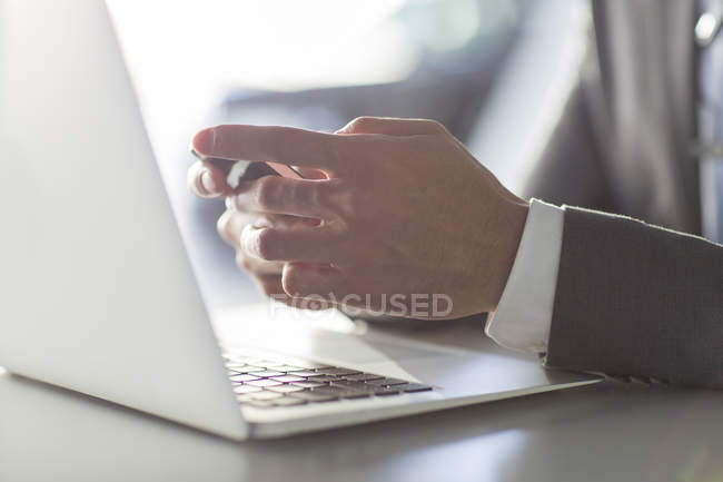 Close-up of male hands using smartphone and laptop — Stock Photo