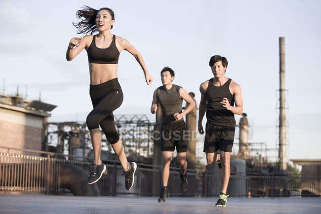 Chinese athletes running on street — Stock Photo