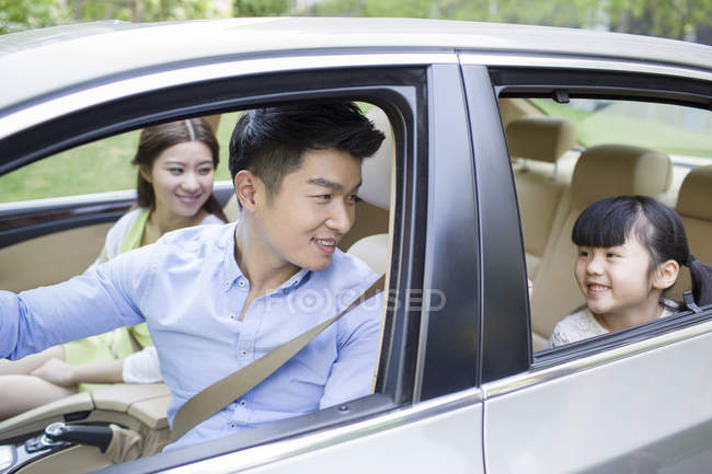 Chinese family riding in car together — Stock Photo