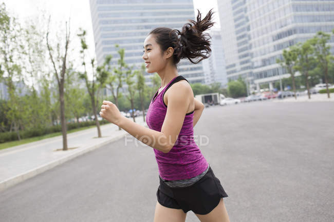 Chinese woman running at street — Stock Photo