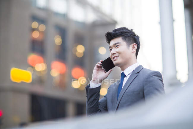 Chinesischer Geschäftsmann telefoniert auf der Straße — Stockfoto