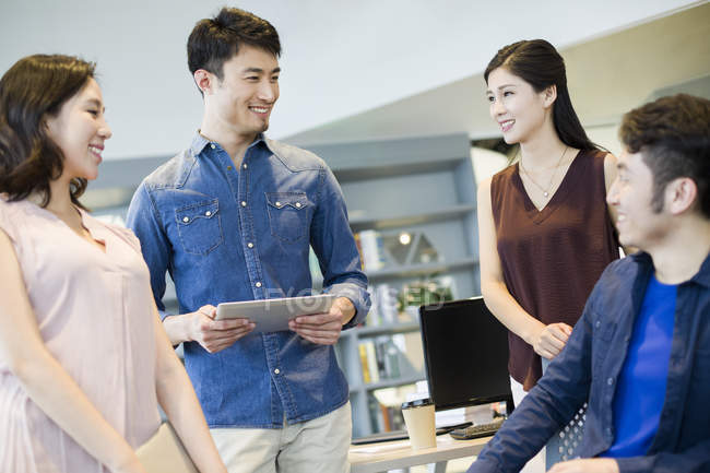 Chinese business team talking in office — Stock Photo