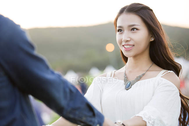 Chinese couple holding hands at music festival — Stock Photo