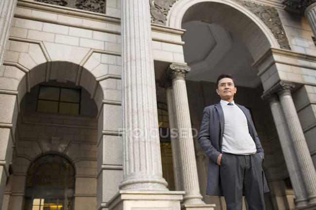 Chinese businessman looking at view in city — Stock Photo