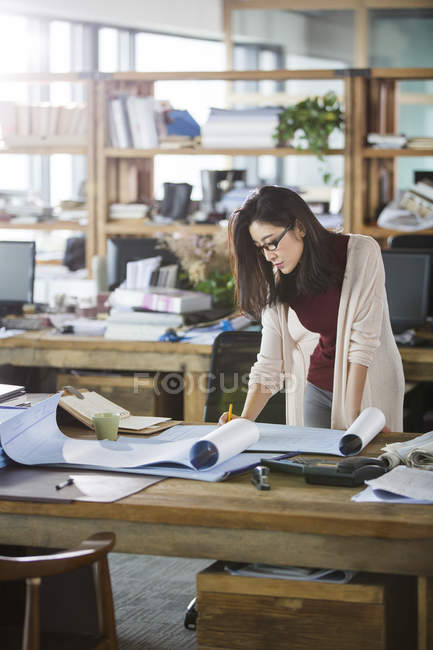 Female architect working at office table — Stock Photo