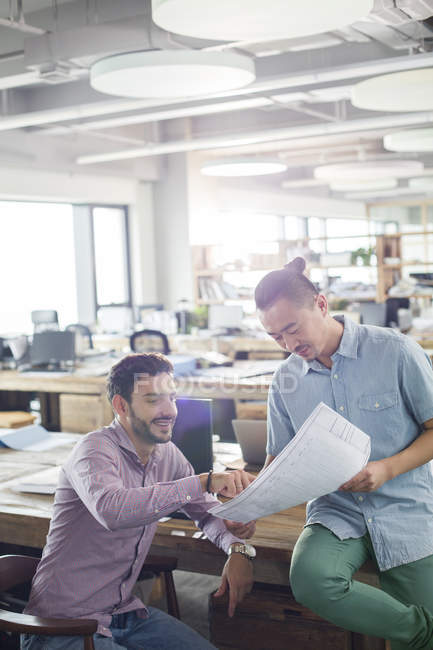 Architects working on blueprint in office — Stock Photo