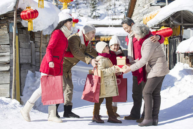 Family visiting grandparents with gifts on Chinese New Year — Stock Photo