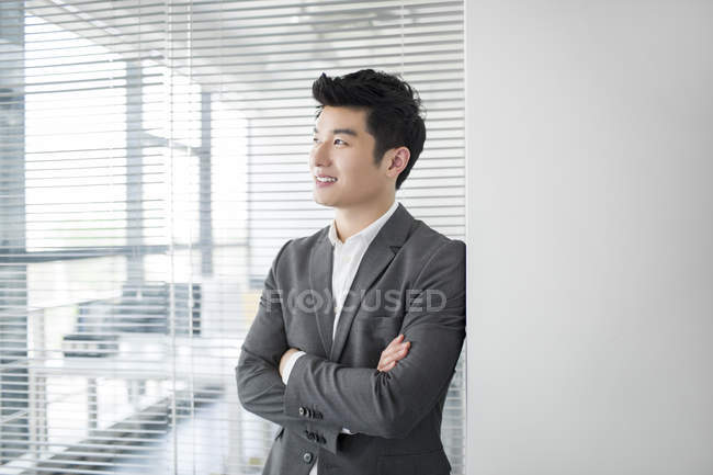 Chinese businessman thinking in office — Stock Photo