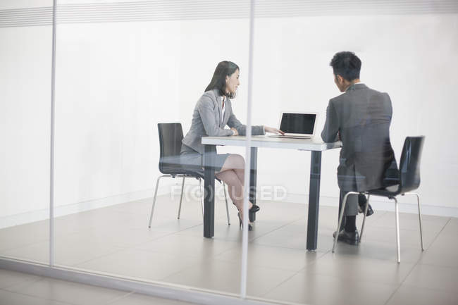 Chinese business people working with laptop in meeting room — Stock Photo