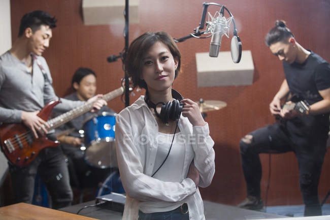 Woman and chinese musical band recording song in studio — Stock Photo