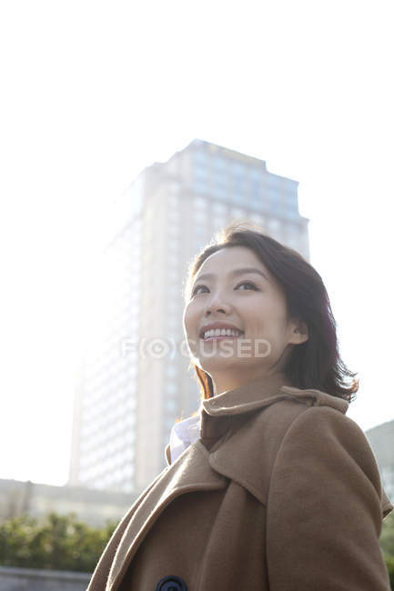 Portrait of smiling Chinese woman in downtown — Stock Photo