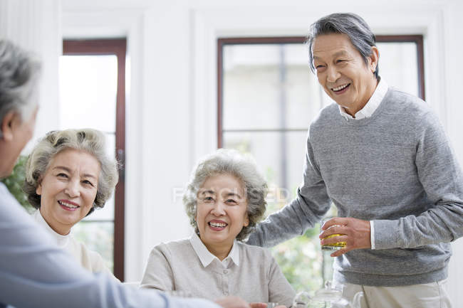 Senior Chinese friends relaxing and talking while tea party — Stock Photo