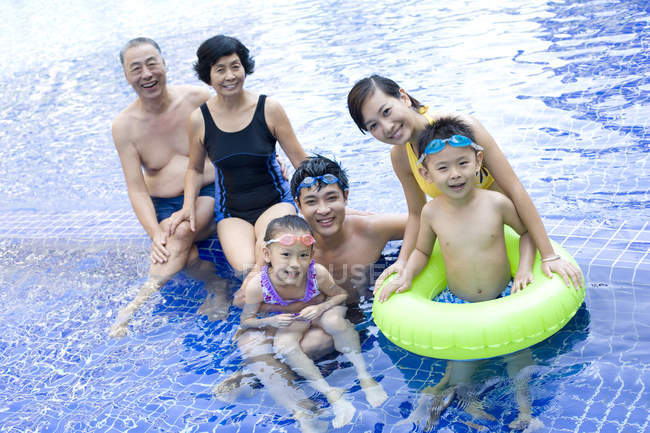 Chinese multi-generation family posing in swimming pool — Stock Photo