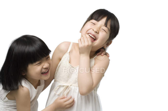 Laughing Chinese little girls on white background — Stock Photo