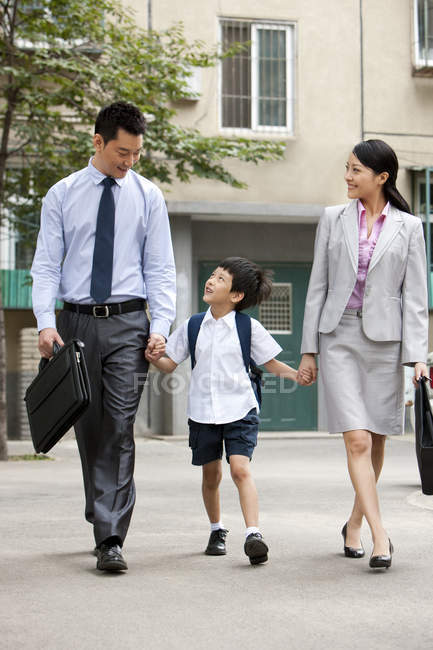 Écolier chinois marchant avec les parents dans la rue — Photo de stock