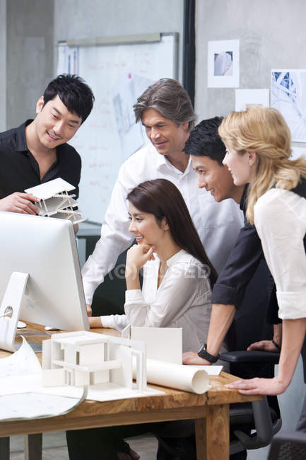 Multi-ethnic group of architects working in office with computer — Stock Photo