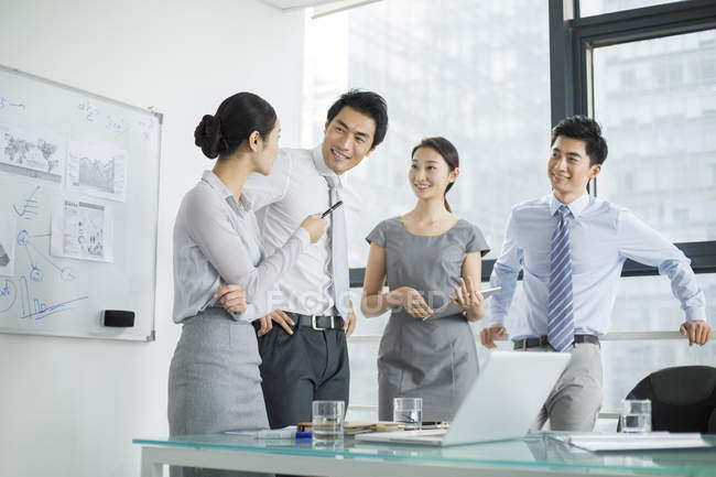 Chinese business team talking in meeting in board room — Stock Photo