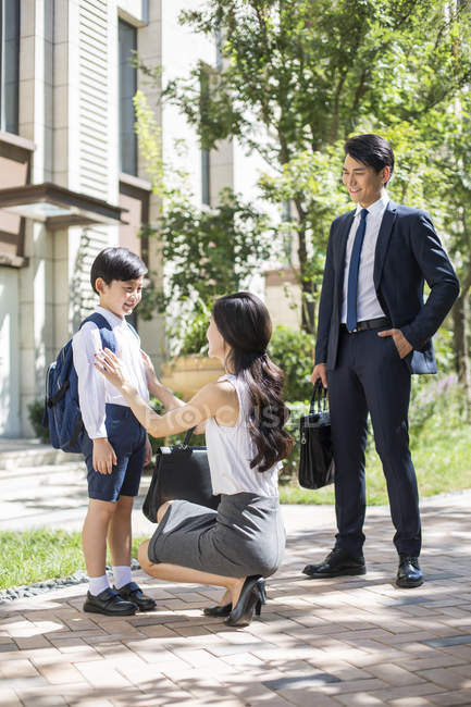 Chinese parents with schoolboy on street in morning — Stock Photo