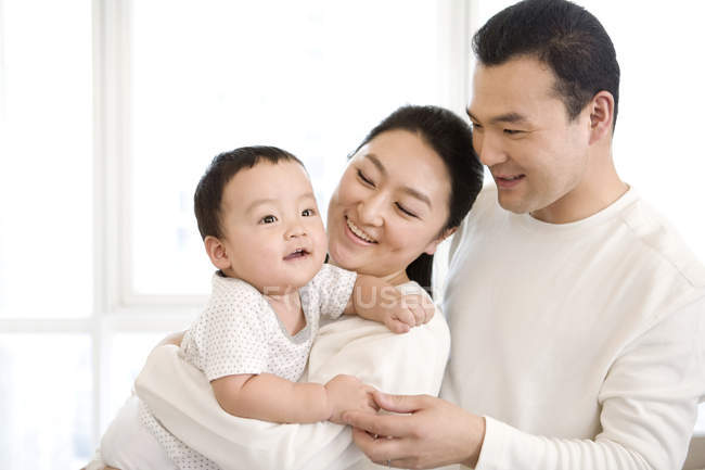 Chinese parents holding baby son — Stock Photo