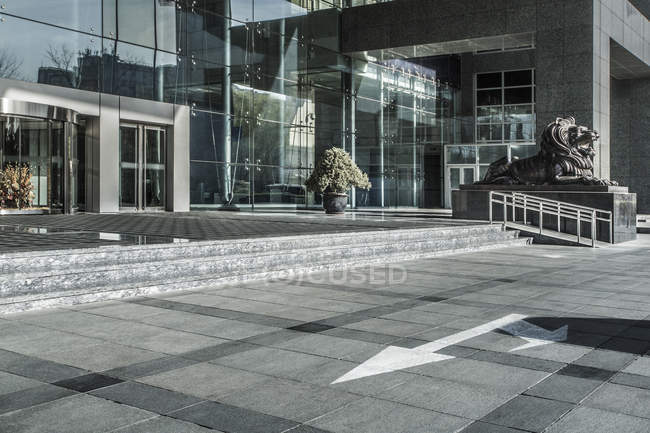 Urban scene of building entrance with lion sculpture, Beijing, China — Stock Photo