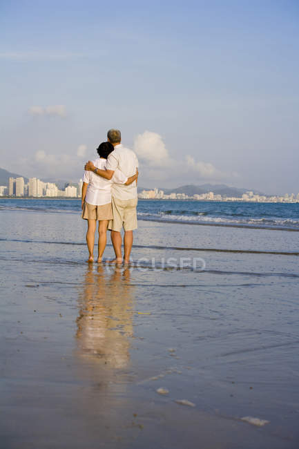 Rear view of senior couple looking into distance at cityscape — Stock Photo