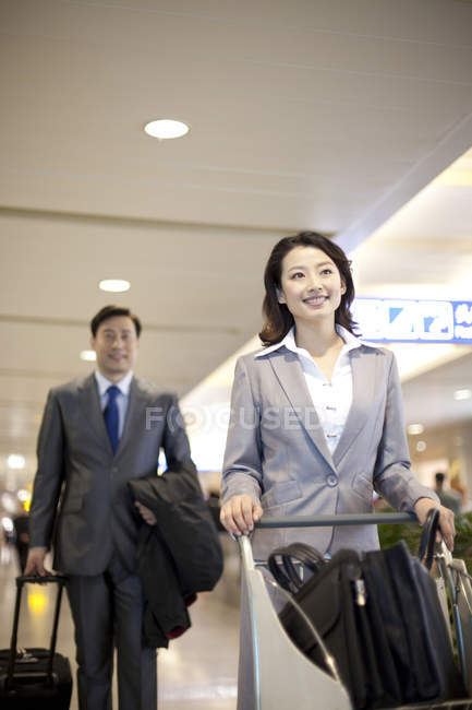 Китайський ділові люди потягнувши багажу в аеропорту — стокове фото
