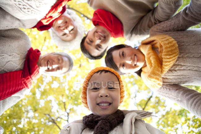 Chinese multi-generation family posing in autumnal park — Stock Photo