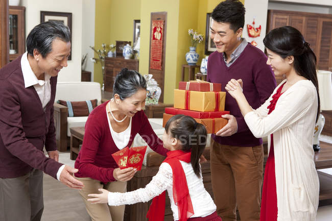 Família com menina visitando avós com presentes durante o Ano Novo Chinês — Fotografia de Stock