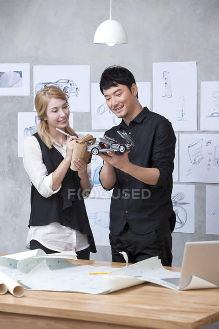 Designers de carro trabalhando com modelo no escritório — Fotografia de Stock