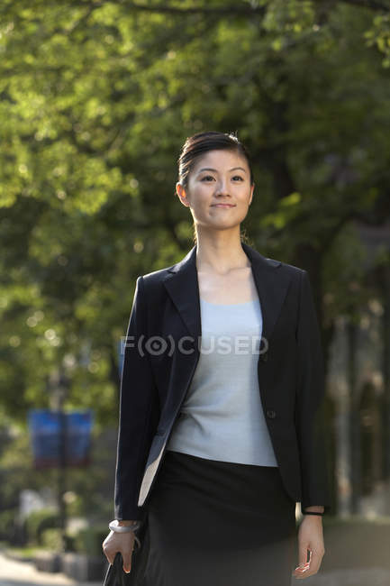 Femme d'affaires chinoise marchant dans la rue — Photo de stock