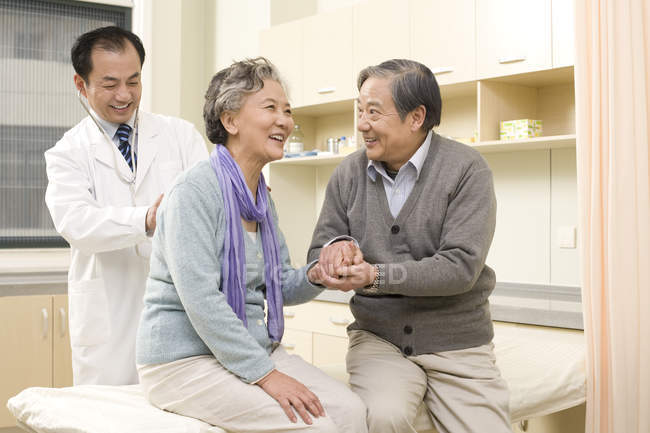 Senior Chinese woman being examined by doctor in hospital — Stock Photo