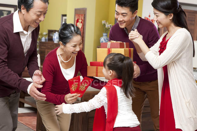 Family with girl visiting grandparents with gifts during Chinese New Year — Stock Photo