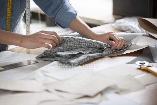 Cropped view of female tailor working in studio with textile — Stock Photo