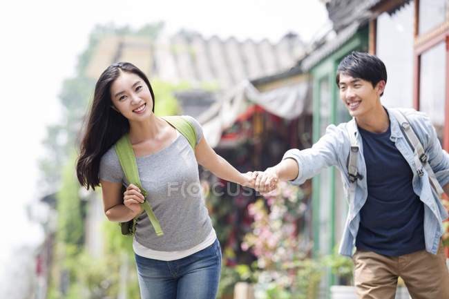 Chinese couple holding hands on street of Beijing — Stock Photo