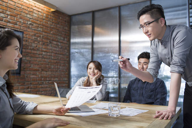 Chinese colleagues discussing work in meeting room — Stock Photo