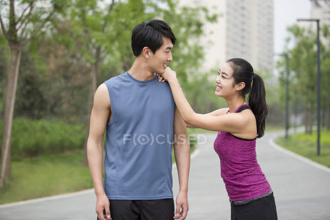 Couple chinois de joggeurs prendre une pause et parler — Photo de stock
