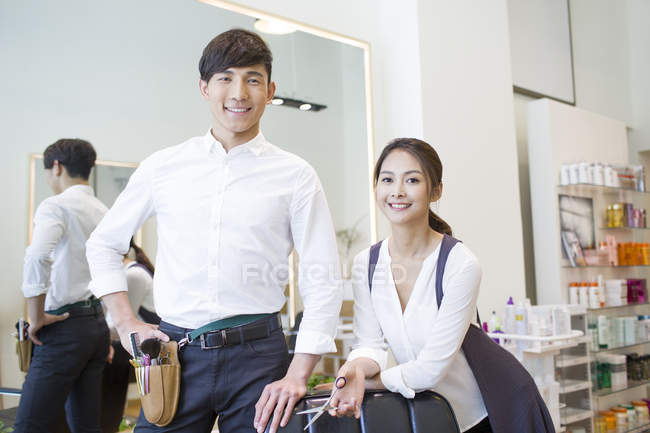 Chinese barbers posing in barber shop — Stock Photo