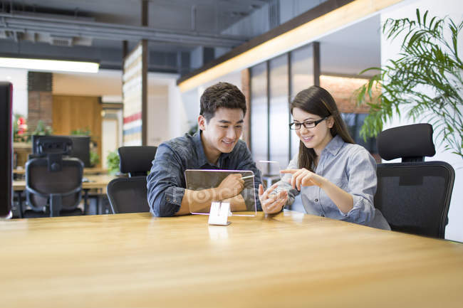 Chinese developers working with transparent models in office — Stock Photo