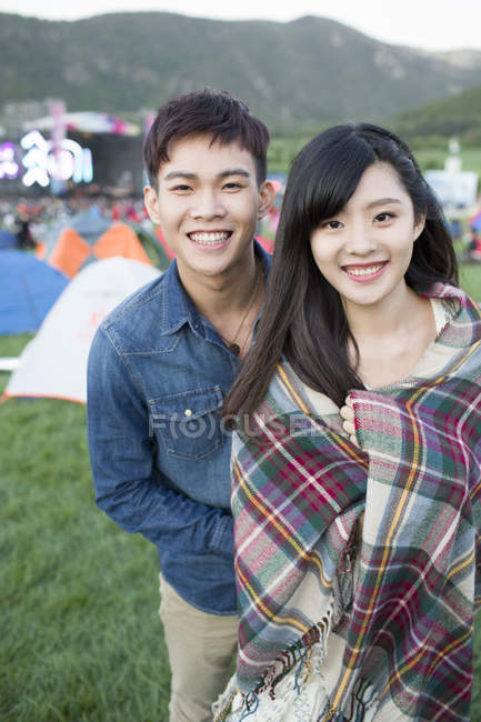 Chinese couple posing at music festival camping — Stock Photo