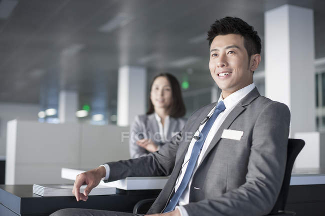 Chinese sale managers sitting in office — Stock Photo