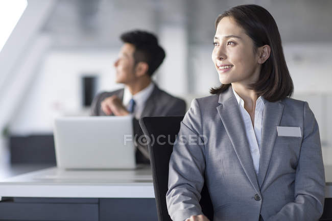 Chinese sale managers sitting in office — Stock Photo