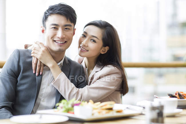 Chinese couple hugging in restaurant — Stock Photo