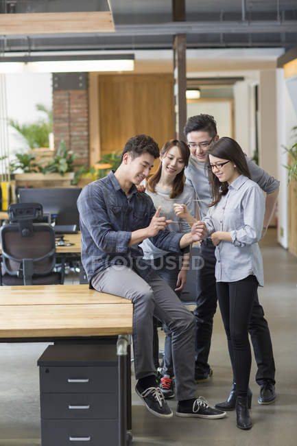 Chinese IT workers developing digital tablet — Stock Photo