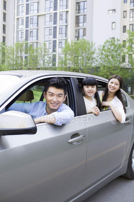 Chinese family riding and leaning out of car — Stock Photo